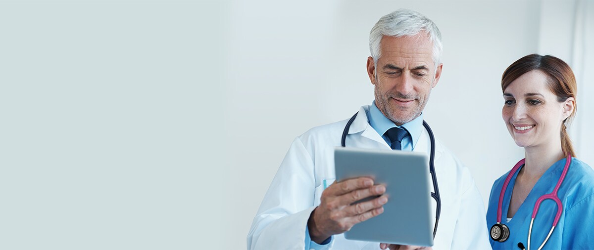 Professor and nursing student working looking at a tablet.

